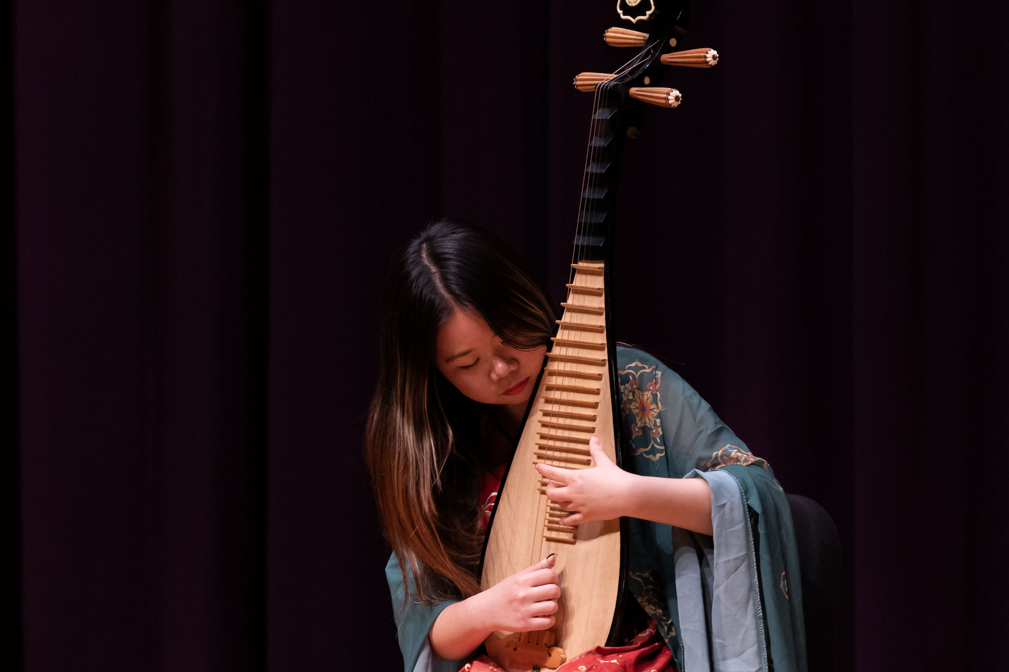 Photo of an instrumentalist playing the pipa