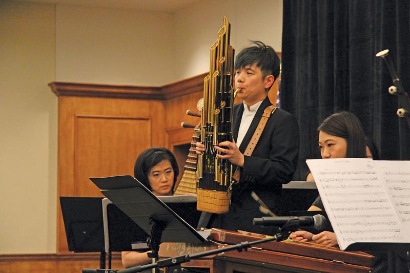 Photo of an instrumentalist playing the sheng